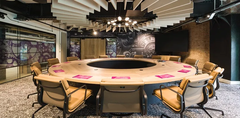 view of a meeting room with table and chairs in the centre of it