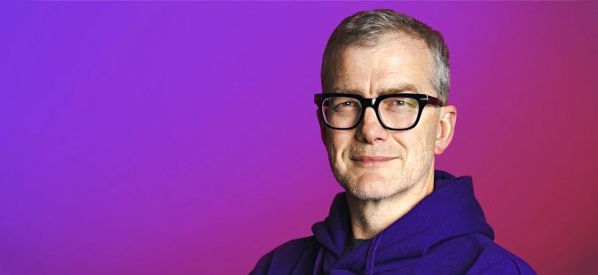 Profile of Mark Mullen, Atom CEO, against a purple and pink gradient background