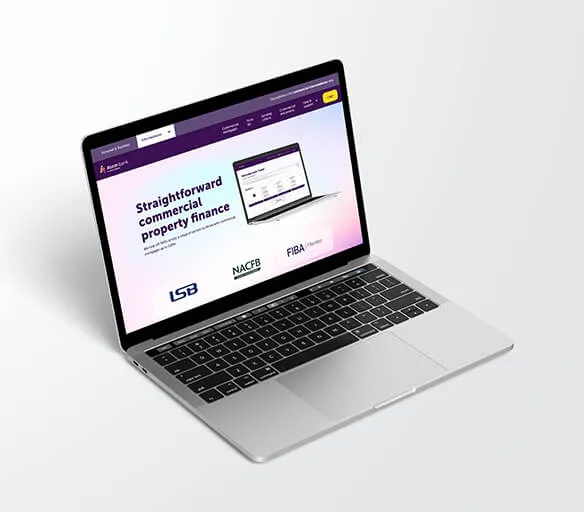 Laptop showing the Atom for Intermediaries Commercial landing page, on a grey background