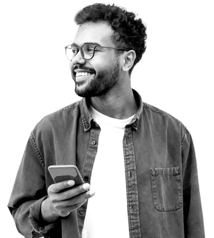 Man smiling looking away from phone