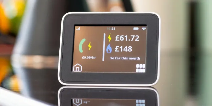 A smart meter and its reflection against the surface, with a blurred background