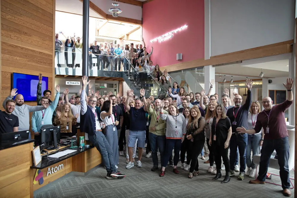 Atom staff gathered around the reception area at Atom HQ