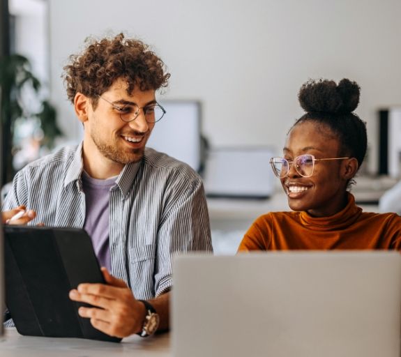 man and woman working on laptops
